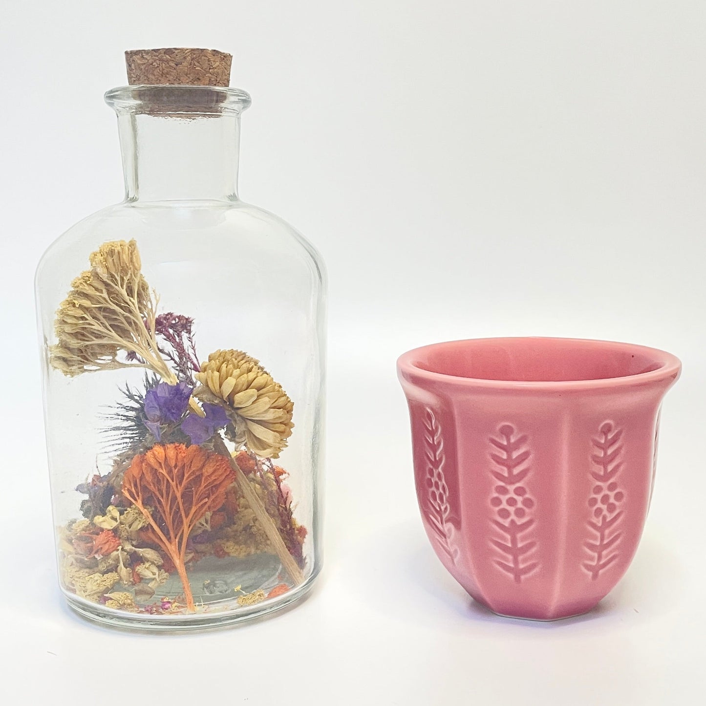 Dried flower apothecary bottle with a match holder that doubles as a coffee or tea cup. 